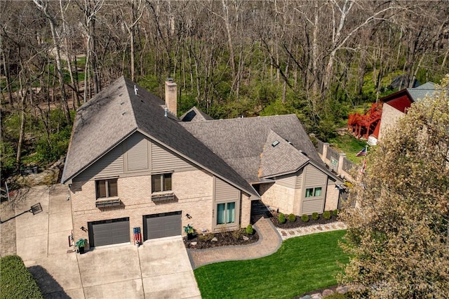 6475 Landsend Ct, Butler Township, OH 45414 - view of front of home featuring a shingled roof, driveway, a wooded view, a front yard, and a garage
