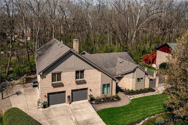6475 Landsend Ct, Butler Township, OH 45414 - view of front of house featuring a front lawn, driveway, a garage, brick siding, and a shingled roof