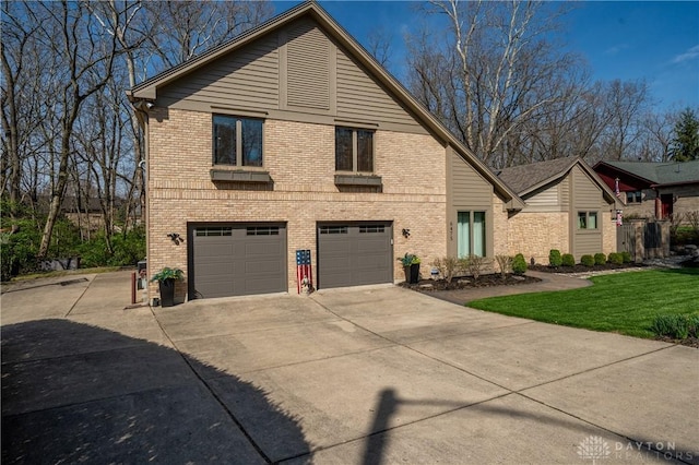 6475 Landsend Ct, Butler Township, OH 45414 - view of front of home with an attached garage, a front lawn, driveway, and brick siding