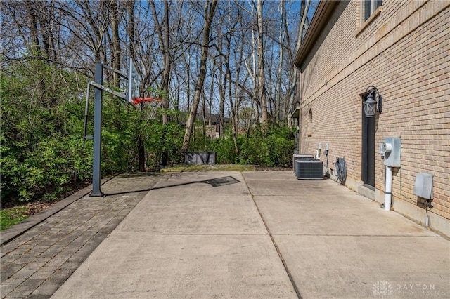 6475 Landsend Ct, Butler Township, OH 45414 - exterior space featuring brick siding, a patio area, and central AC unit