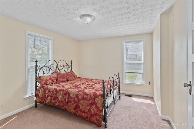 40 E Pease Ave, Dayton, OH 45449 - bedroom with visible vents, carpet, a textured ceiling, and multiple windows