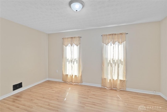 40 E Pease Ave, Dayton, OH 45449 - spare room featuring wood finished floors, a textured ceiling, and baseboards