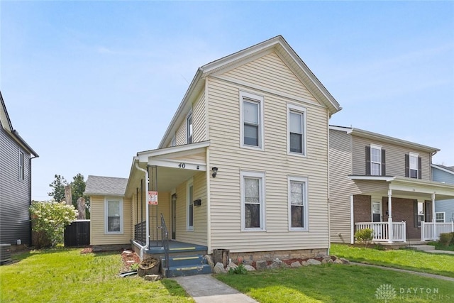 40 E Pease Ave, Dayton, OH 45449 - view of front of home featuring central air condition unit, a front lawn, and a porch