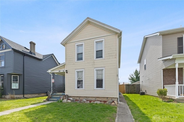 40 E Pease Ave, Dayton, OH 45449 - rear view of property with cooling unit, a yard, and fence