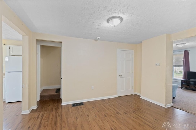 40 E Pease Ave, Dayton, OH 45449 - empty room featuring visible vents, baseboards, wood finished floors, and a textured ceiling