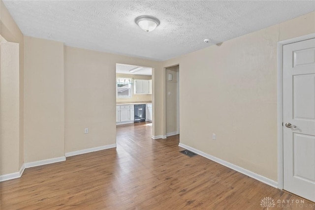 40 E Pease Ave, Dayton, OH 45449 - empty room with a textured ceiling, wood finished floors, visible vents, and baseboards