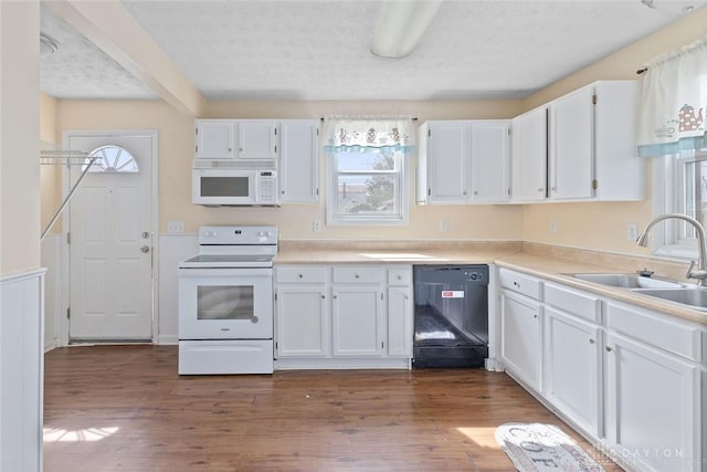 40 E Pease Ave, Dayton, OH 45449 - kitchen with white cabinets, a wealth of natural light, white appliances, and a sink