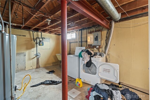 basement featuring electric panel, gas water heater, and washing machine and clothes dryer