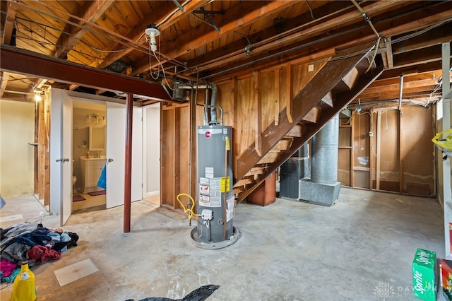 unfinished below grade area featuring stairway and gas water heater