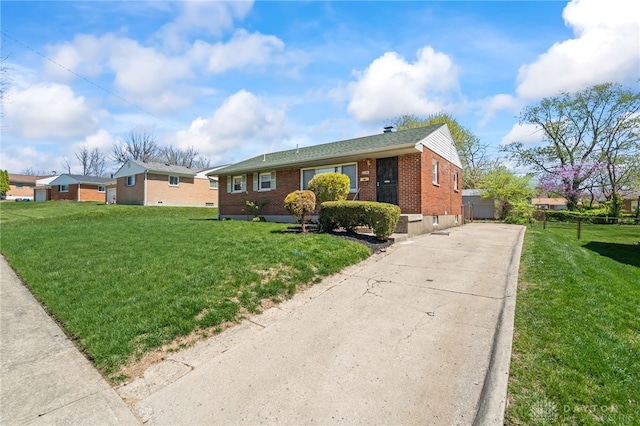ranch-style home with a front lawn, driveway, and brick siding