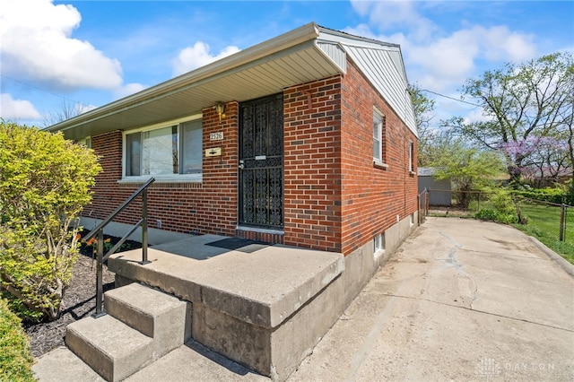 view of front of home with fence and brick siding