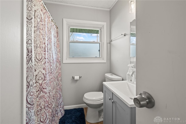bathroom featuring a shower with shower curtain, toilet, and vanity