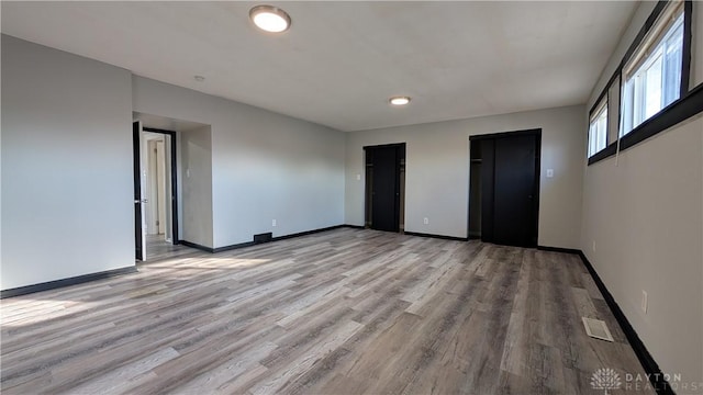 1105 Pursell Ave, Dayton, OH 45420 - unfurnished bedroom with light wood finished floors and multiple closets