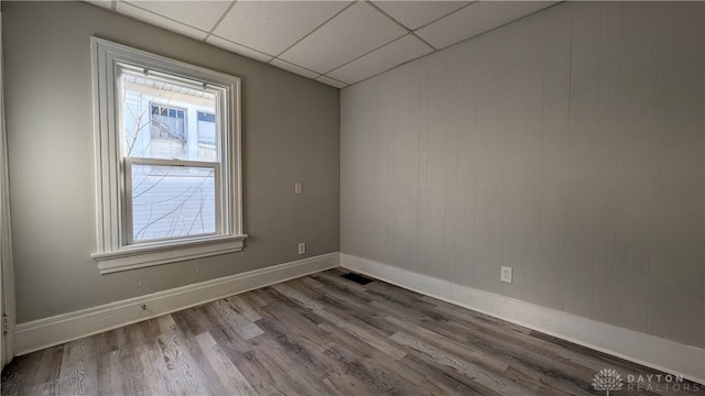 1105 Pursell Ave, Dayton, OH 45420 - unfurnished room featuring plenty of natural light, wood finished floors, and a paneled ceiling