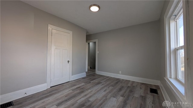 1105 Pursell Ave, Dayton, OH 45420 - unfurnished bedroom with multiple windows and wood finished floors