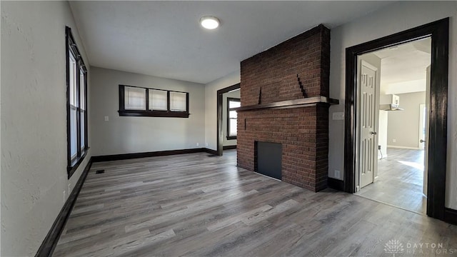 1105 Pursell Ave, Dayton, OH 45420 - unfurnished living room with wood finished floors and a fireplace
