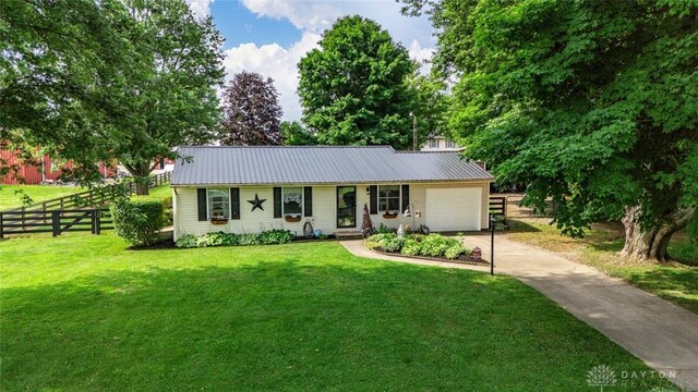 4065 Apache Trl, Jamestown Vlg, OH 45335 - single story home featuring concrete driveway, a garage, and metal roof