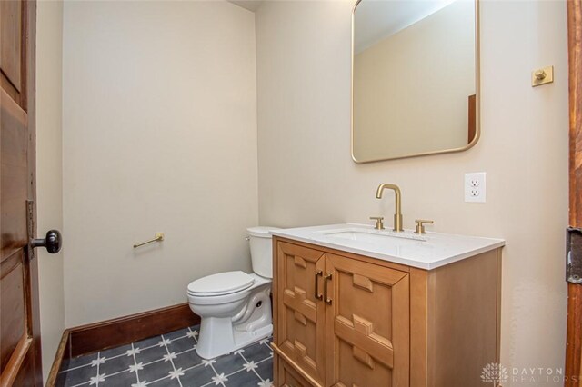 117 Montgomery Ave, Franklin, OH 45005 - bathroom featuring baseboards, toilet, vanity, and tile patterned floors