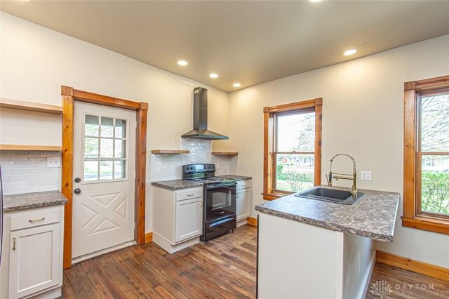 117 Montgomery Ave, Franklin, OH 45005 - kitchen with a peninsula, a sink, dark wood-style flooring, electric range, and wall chimney range hood