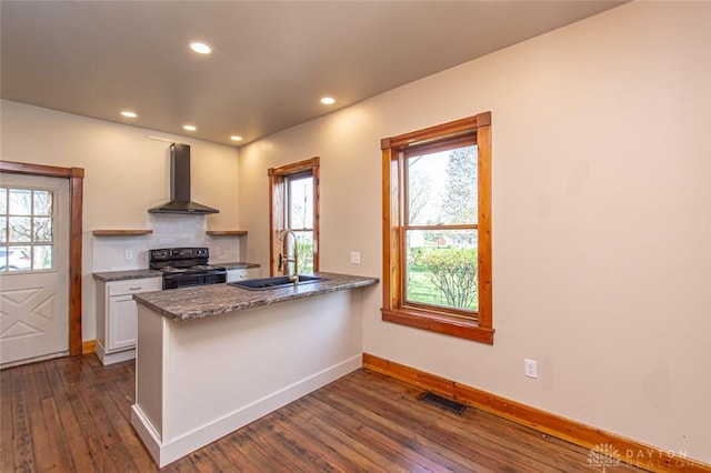 117 Montgomery Ave, Franklin, OH 45005 - kitchen featuring wall chimney range hood, a sink, black electric range, dark wood-type flooring, and visible vents