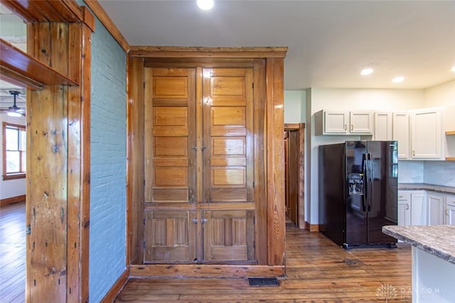 117 Montgomery Ave, Franklin, OH 45005 - kitchen with black fridge with ice dispenser, white cabinetry, dark wood-style floors, and baseboards