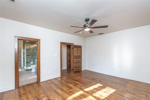 117 Montgomery Ave, Franklin, OH 45005 - unfurnished bedroom with visible vents, a ceiling fan, connected bathroom, wood-type flooring, and baseboards