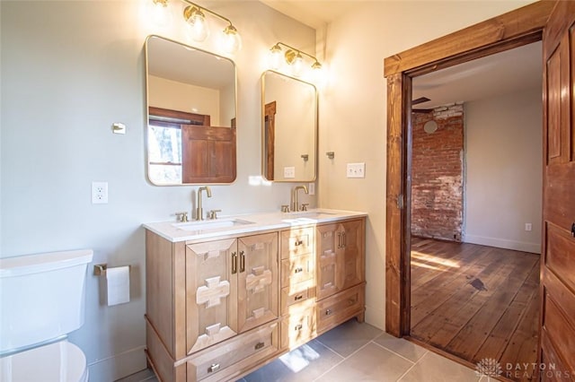 117 Montgomery Ave, Franklin, OH 45005 - full bathroom featuring double vanity, tile patterned floors, toilet, and a sink