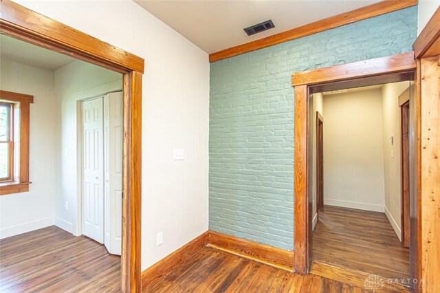 117 Montgomery Ave, Franklin, OH 45005 - hall with brick wall, baseboards, wood finished floors, and visible vents