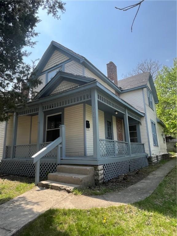 400 S Detroit St, Xenia, OH 45385 - view of front facade featuring covered porch and a chimney