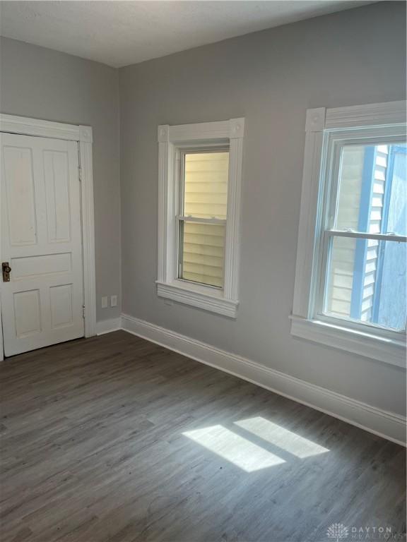 400 S Detroit St, Xenia, OH 45385 - empty room with dark wood-style flooring, baseboards, and plenty of natural light