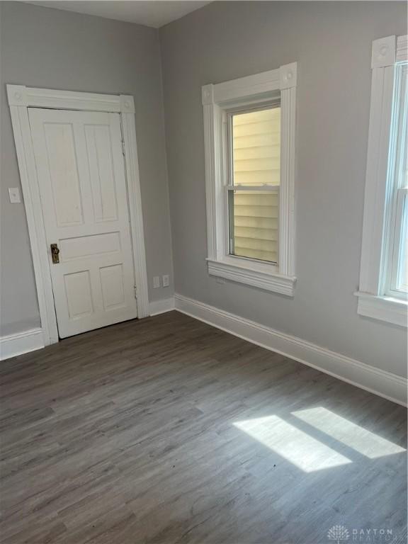 400 S Detroit St, Xenia, OH 45385 - unfurnished bedroom featuring dark wood-style floors and baseboards