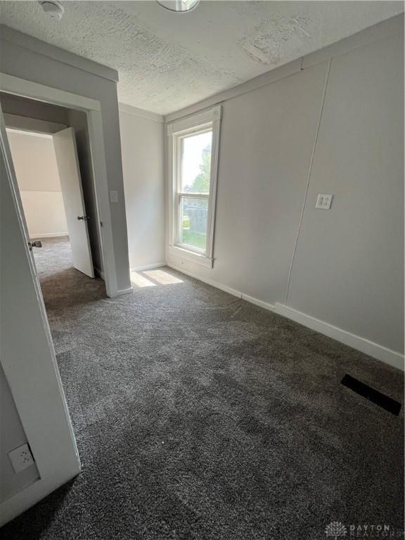 400 S Detroit St, Xenia, OH 45385 - carpeted empty room featuring a textured ceiling