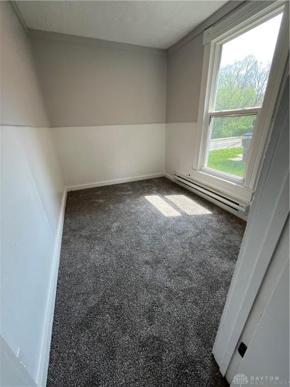 400 S Detroit St, Xenia, OH 45385 - spare room with baseboard heating, carpet floors, and baseboards