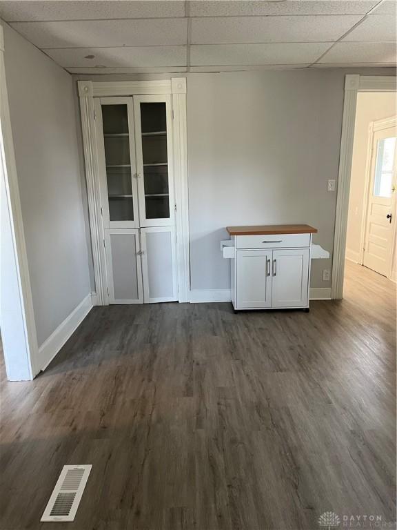 400 S Detroit St, Xenia, OH 45385 - unfurnished dining area featuring a drop ceiling, baseboards, and dark wood finished floors
