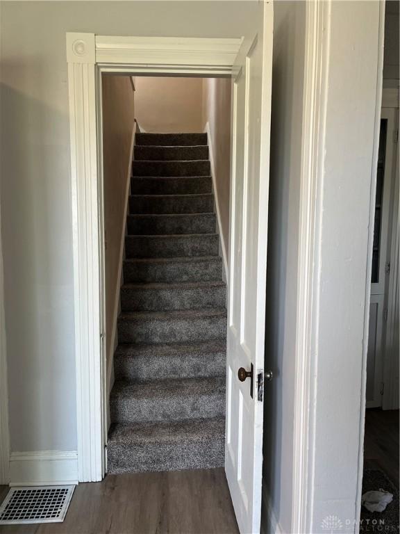 400 S Detroit St, Xenia, OH 45385 - staircase with baseboards and wood finished floors