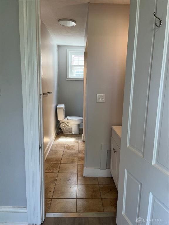 400 S Detroit St, Xenia, OH 45385 - bathroom with toilet, baseboards, vanity, and tile patterned floors