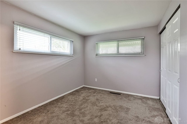 320 Orangewood Dr, Dayton, OH 45429 - unfurnished bedroom with baseboards, visible vents, carpet floors, and a closet