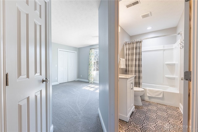 bathroom with a textured ceiling, vanity, shower / tub combo, baseboards, and visible vents