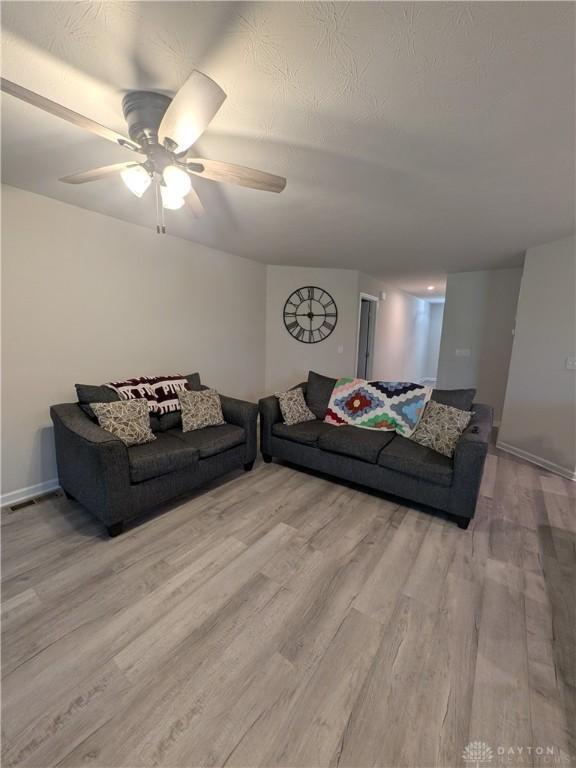 2408 Valleybrook Ct, Batavia, OH 45103 - living area with wood finished floors, a ceiling fan, and baseboards