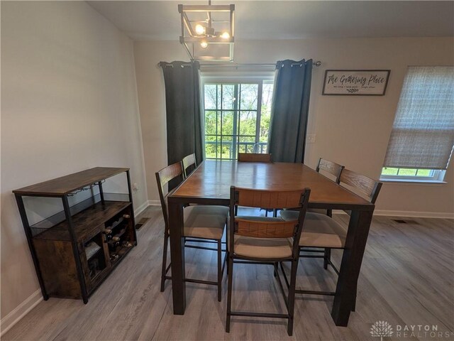 2408 Valleybrook Ct, Batavia, OH 45103 - dining room featuring light wood-style floors, a healthy amount of sunlight, and baseboards