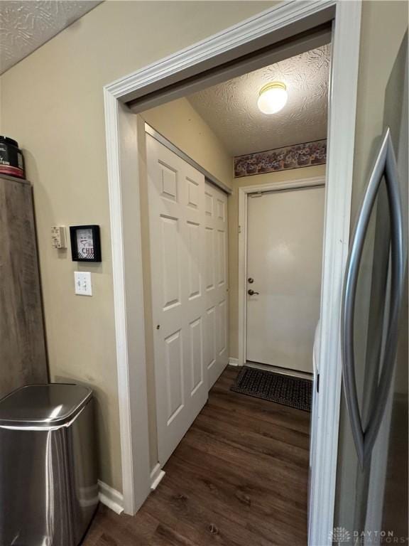 9632 Belfry Ct, Dayton, OH 45458 - doorway with baseboards, a textured ceiling, and dark wood-type flooring