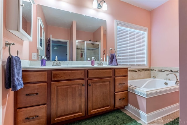 full bathroom featuring vanity, a stall shower, and a bath