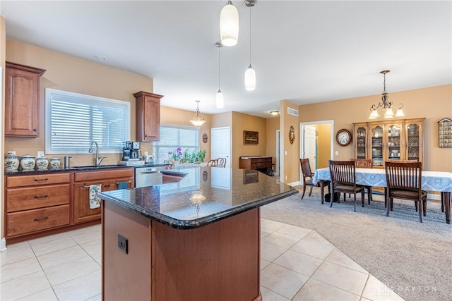 kitchen featuring a kitchen island, dishwasher, light colored carpet, a sink, and light tile patterned floors