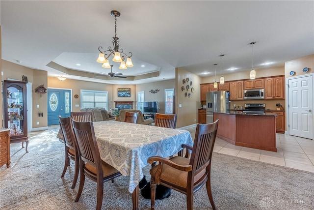 dining area with light carpet, recessed lighting, baseboards, light tile patterned floors, and a tray ceiling