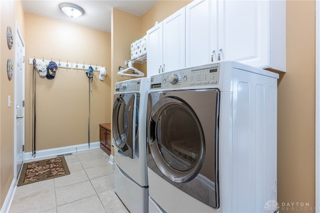 clothes washing area with light tile patterned floors, separate washer and dryer, baseboards, and visible vents