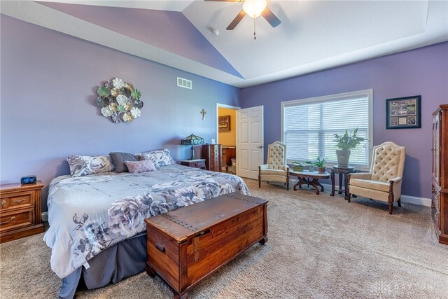 carpeted bedroom with ceiling fan, visible vents, and vaulted ceiling