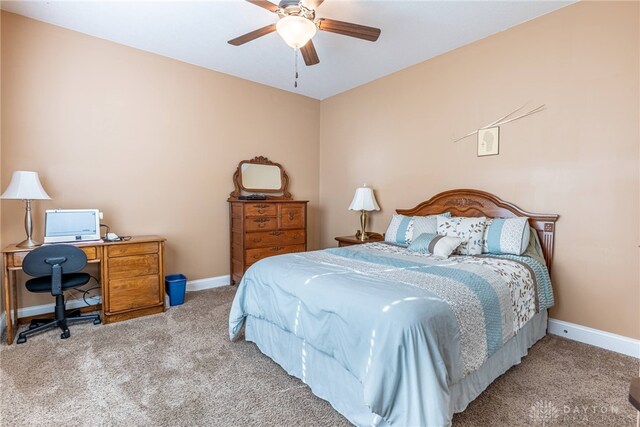 carpeted bedroom featuring a ceiling fan and baseboards