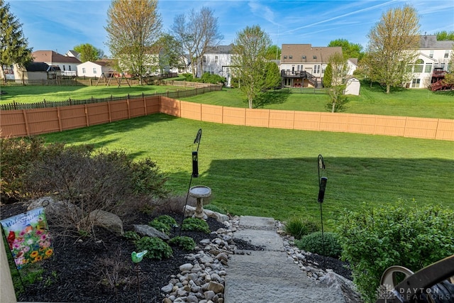 view of yard featuring fence and a residential view