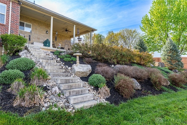 view of yard with stairway and ceiling fan