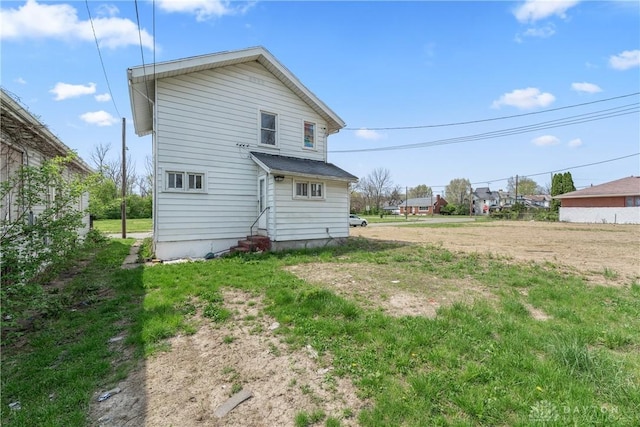 rear view of property with entry steps